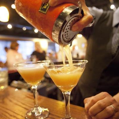 Bartender preparing handcrafted cocktails at Carlos & Carlos